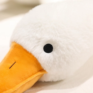 Close-up of soft plush white goose toy featuring a vibrant orange beak and smooth texture