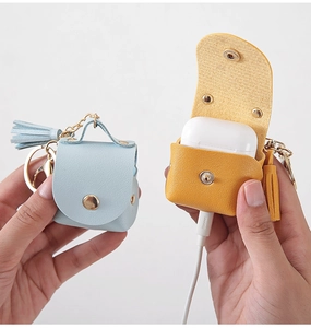 Detailed view of yellow and blue PU leather mini pouches for AirPods case charging