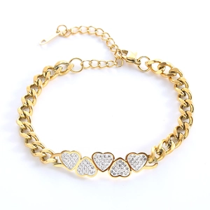 Gold chain bracelet featuring five heart pendants with pave set sparkling rhinestones
