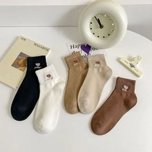 Detail of candy-colored low cut socks with cute heel tab and heart embroidery