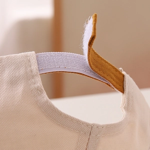 Close-up of the adjustable Velcro strap on a cotton baby cap with high-quality stitching