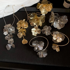 Detail of gold and silver hollow flower necklaces with intricate woven wire design
