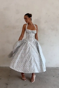 Detail of floral halter dress showing waist corset structure and flowy white A-line skirt