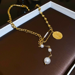 Vintage gold necklace with coin pendant, paperclip pin, and white pearls for women