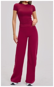Close-up of wine red yoga set featuring high-waist wide-leg pants and slim-fit tee