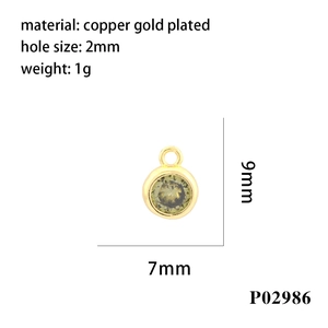 Macro detail of a 7x9mm gold plated copper charm with a green faceted zircon stone