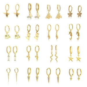 16 pairs of gold hoop earrings with animal and geometric pendants set in a grid layout