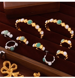 Detailed flat lay of vintage titanium steel jewelry set with natural green stone inlays