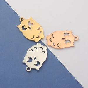 Detailed view of owl-shaped pendants in gold, silver, and rose gold polished finishes