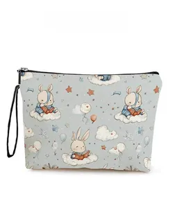 Detail of blue canvas makeup bag featuring cartoon rabbit print and black zipper closure