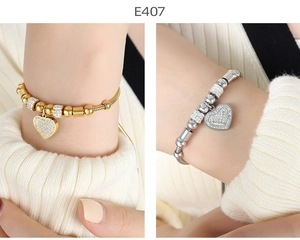 Detail of gold and silver snake chains with sparkling rhinestone heart charms