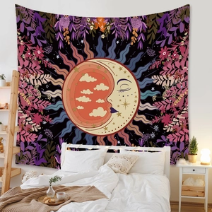 Detail view of Bohemian sun and moon tapestry with purple floral patterns on bedroom wall