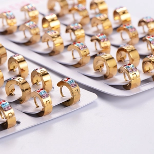 Gold stainless steel hoop earrings set with colorful crystals on white card display