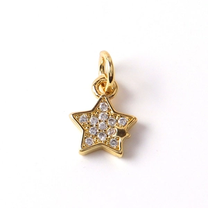 Macro view of a gold-plated star pendant with micro-pave cubic zirconia inlay detail