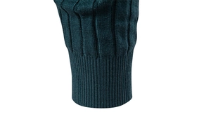 Detail view of elastic ribbed cuffs and textured cable knit fabric on a dark teal sweater