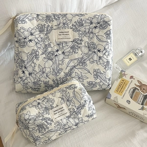 Quilted floral toiletry bag set including laptop sleeve and cosmetic pouch in white and blue