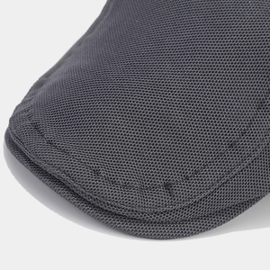 Macro shot of dark grey knitted fabric texture on the brim of a retro flat cap