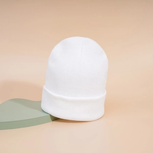 Detailed close-up showing the fine knit texture and folded cuff of this white beanie hat