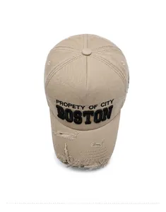 Top view of beige distressed denim baseball cap with Boston embroidery and ripped brim