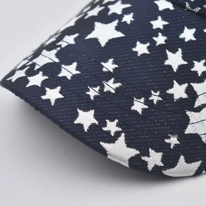 Detailed close-up of navy blue baseball cap brim with silver star patterns and reinforced stitching