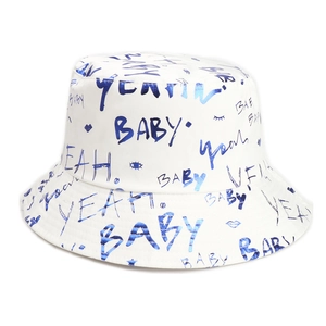Detail of white bucket hat featuring blue graffiti BABY letters and artistic doodles