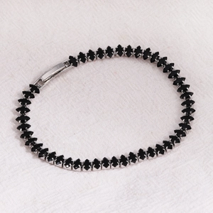 Detail of silver tennis bracelet with marquise-cut black zircons and secure clasp