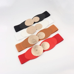 Detail view of elastic waist belts featuring double circular gold buckles and textured finish