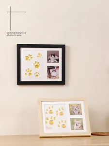 Detailed close-up of pet paw print keepsake frame set in wood and black finish