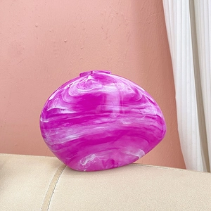 Detail view of acrylic shell bag with purple marble texture and elegant stone grain
