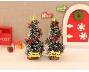 Detail showing two mini cedar Christmas trees with wood base and Merry Christmas sign