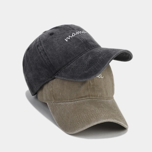 Close-up of vintage washed cotton baseball caps with embroidered white mama lettering