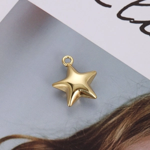 Macro shot of 18K gold-plated star pendant with polished finish and metal connector ring
