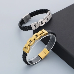 Detail of men's leather bracelets with gold and silver chain accents and magnetic clasps