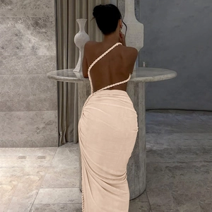 Detail of cross-back rope straps and ruched fabric texture on an apricot backless dress