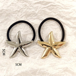 Close-up of 5cm hollow starfish hair ties in polished gold and silver metal finishes