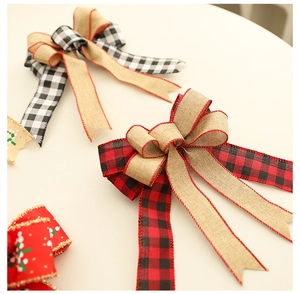 Detailed macro view of rustic plaid Christmas bows with red stitched edges for decor