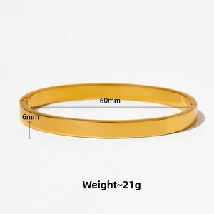 Close-up of polished gold-plated stainless steel bangle with 60mm diameter and 6mm width