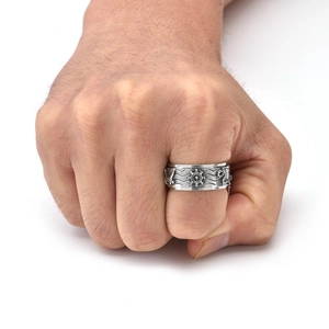 Detailed relief of ship helm and ocean waves on a vintage punk stainless steel spinner ring