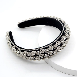 Macro detail of luxury black velvet headband with sparkling crystal rhinestones set on white
