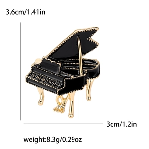 Elegant black enamel and gold piano brooch with detailed keys and dimension markings