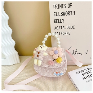 Detail of pink girls' crossbody bag with pearl handle and plush bear charm