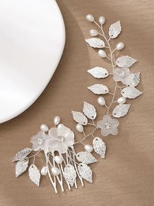 Detail view of handmade silver leaf hair comb with frosted flowers and white pearls