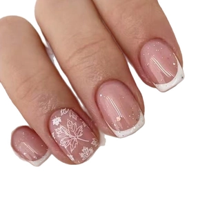 French tip press-on nails with autumn maple leaf design in soft nude pink with glitter