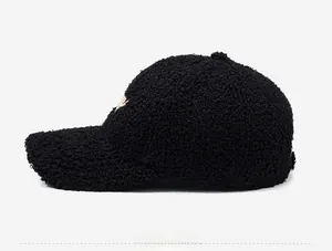 Detailed side view of black fleece baseball cap with warm texture and gold embroidery