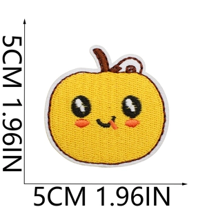 Detail view of 5cm embroidered yellow pumpkin patch with cute facial expressions