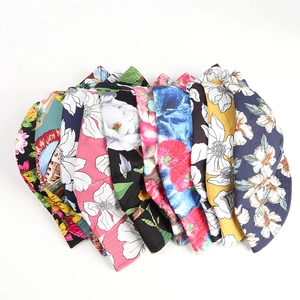 Detailed assortment of reversible floral sun hats featuring tropical hibiscus and sunflower patterns