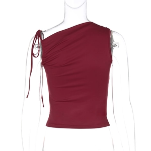 Detailed close-up of wine red asymmetrical crop top with adjustable side drawstring detail