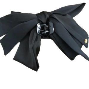 Elegant large black fabric bow claw clip with gold metal eyelet on white background