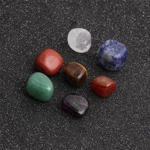 Set of 7 natural polished crystal stones for meditation on a dark starry background