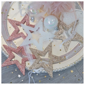 Glittering star Christmas ornaments in pink, white and gold with elegant mesh ribbons